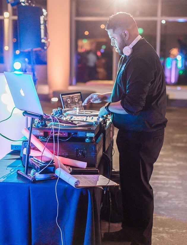 dj playing music with multiple computers and equipment in ballroom at brannon center florida